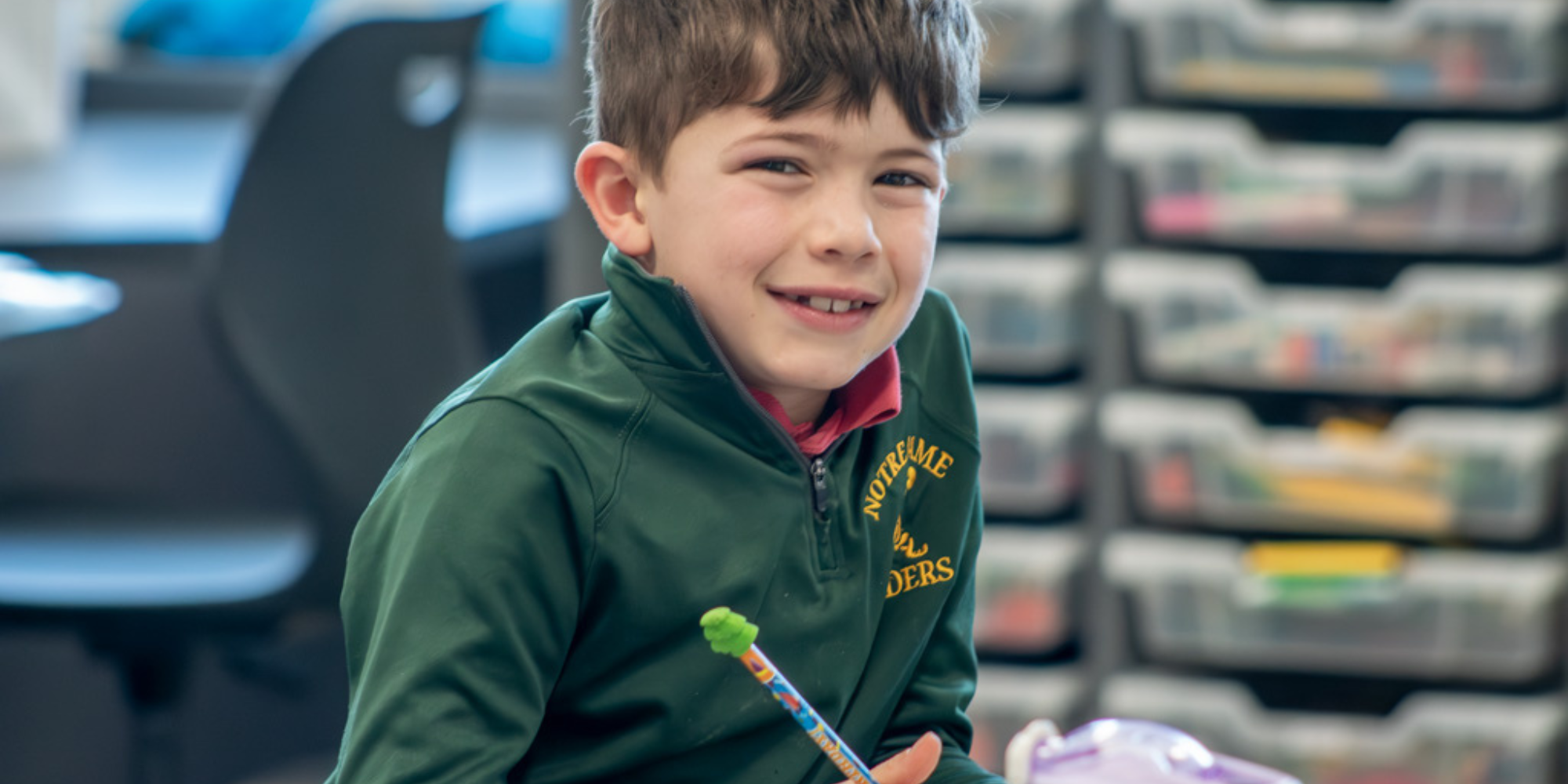 Notre Dame of De Pere Catholic School student sitting in classroom with pencil